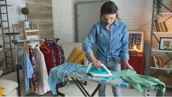 Steam rising from an ironing board during a silk fabric press.