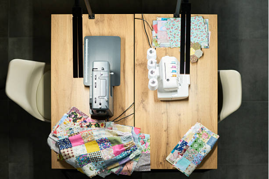 Height-adjustable ironing board for comfortable quilting and sewing setup.