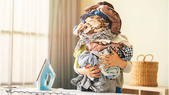 An overloaded closet with many wrinkled clothes, illustrating the Wardrobe Paradox.