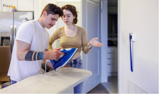family members using ironing board together