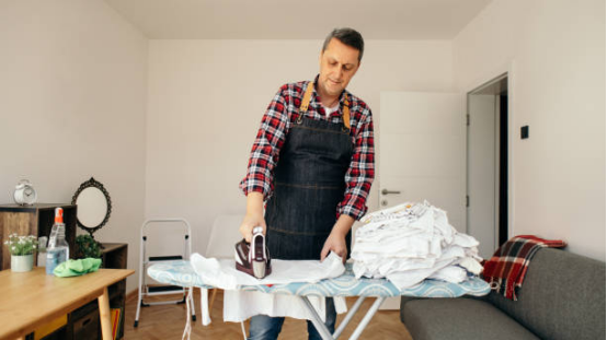 clothes moving through washing and ironing board process