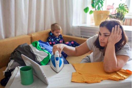Dedicated ironing area with ironing board and organized clothes