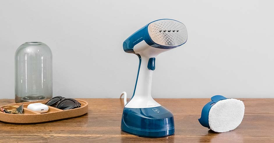 Handheld garment steamer, an alternative to a traditional ironing board setup.